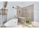 Bright bathroom showcasing a soaking tub, elegant decor, and a tiled walk-in shower at 553 Haven Point Dr, Treasure Island, FL 33706
