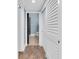 Hallway leading to bathroom with wood floors and access to closet at 553 Haven Point Dr, Treasure Island, FL 33706