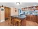 Open kitchen featuring a large island with barstool seating, wood cabinets, and views to the living area at 553 Haven Point Dr, Treasure Island, FL 33706