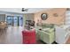 Comfortable living room with stone fireplace, wood floors, and waterfront views from the sliding glass door at 553 Haven Point Dr, Treasure Island, FL 33706