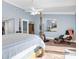 Spacious bedroom featuring a four-poster bed, wood floors, and a relaxing sitting area at 553 Haven Point Dr, Treasure Island, FL 33706