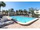Inviting community pool with plenty of lounge chairs for relaxing and enjoying the sunny outdoor setting at 553 Haven Point Dr, Treasure Island, FL 33706