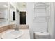 Clean and bright bathroom featuring a single sink, modern fixtures, and a toilet at 5745 Pawnee St, Zephyrhills, FL 33542