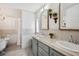 Well-lit bathroom showcases double sinks, framed mirrors, shiplap accents, tub and walk-in shower at 5745 Pawnee St, Zephyrhills, FL 33542