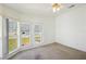 Bright bedroom featuring a bay window that overlooks the front yard at 5745 Pawnee St, Zephyrhills, FL 33542