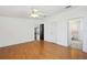 Bright bedroom with hardwood floors and views to the kitchen and bathroom at 5745 Pawnee St, Zephyrhills, FL 33542