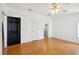 Bright bedroom features hardwood floors and ensuite bathroom at 5745 Pawnee St, Zephyrhills, FL 33542