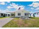 Charming single-story home featuring a carport, manicured lawn, and decorative stonework at 5745 Pawnee St, Zephyrhills, FL 33542