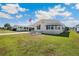 Well-maintained home exterior with vinyl siding, manicured lawn, and mature landscaping at 5745 Pawnee St, Zephyrhills, FL 33542