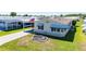 An inviting home with a well-kept lawn, covered parking and a decorative circular garden bed at 5745 Pawnee St, Zephyrhills, FL 33542