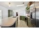 Bright kitchen with stainless steel appliances, green cabinets, and a large island with a sink at 5745 Pawnee St, Zephyrhills, FL 33542