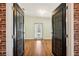 Inviting living room featuring warm hardwood floors and abundant natural light through the window at 5745 Pawnee St, Zephyrhills, FL 33542