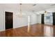 Bright living room boasts wood floors, chandelier lighting, and neutral paint at 5745 Pawnee St, Zephyrhills, FL 33542
