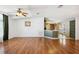 Open living area features hardwood flooring and a ceiling fan at 5745 Pawnee St, Zephyrhills, FL 33542