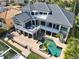 Stunning aerial view of a modern two-story home with a private pool and waterfront access at 6113 Pasadena Point Blvd, Gulfport, FL 33707