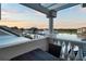 Balcony view overlooking the water and boat docks at sunset, showing the patio table at 6113 Pasadena Point Blvd, Gulfport, FL 33707