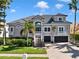 Charming two-story home featuring lush landscaping, a brick driveway and a two-car garage at 6113 Pasadena Point Blvd, Gulfport, FL 33707