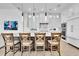 Modern kitchen with a large island, barstool seating, stainless steel appliances, and sleek cabinetry at 6113 Pasadena Point Blvd, Gulfport, FL 33707