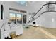 Bright living room features tile floors, soaring ceilings, large windows, and sliding door to a private balcony at 6113 Pasadena Point Blvd, Gulfport, FL 33707