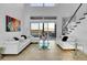 Bright living room features tile floors, soaring ceilings, large windows, and sliding door to a private balcony at 6113 Pasadena Point Blvd, Gulfport, FL 33707