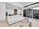 Open-concept living room with modern decor, seamless flow to the outdoor space through sliding glass doors at 6113 Pasadena Point Blvd, Gulfport, FL 33707
