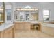 Luxurious bathroom with dual vanities, a makeup table, a soaking tub, and natural light at 6113 Pasadena Point Blvd, Gulfport, FL 33707