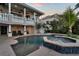 The pool and spa are perfect for relaxing and entertaining. Features a patio lounging area and lush landscaping at 6113 Pasadena Point Blvd, Gulfport, FL 33707