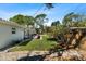 Backyard showcasing manicured lawn, patio area, privacy fence, and mature trees at 6531 2Nd N Ave, St Petersburg, FL 33710