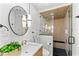 Spa-like bathroom featuring glass shower with seating, modern vanity and stylish lighting fixtures at 6531 2Nd N Ave, St Petersburg, FL 33710