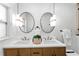 Elegant bathroom with a double vanity, stylish lighting fixtures, and modern finishes at 6531 2Nd N Ave, St Petersburg, FL 33710