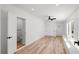 Light-filled bedroom with hardwood floors, ceiling fan, closet, and bathroom with modern fixtures at 6531 2Nd N Ave, St Petersburg, FL 33710