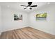 Bright bedroom with hardwood floors, a ceiling fan and two windows at 6531 2Nd N Ave, St Petersburg, FL 33710