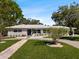 Exterior shot of a well-kept home displays landscaping, driveway, and natural light at 6531 2Nd N Ave, St Petersburg, FL 33710