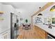 Well-lit modern kitchen with stainless steel appliances and a view into the dining and living areas at 6531 2Nd N Ave, St Petersburg, FL 33710