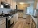 Traditional kitchen with full-sized appliances, light colored cabinets, and light gray countertop at 665 54Th S St # 133, Gulfport, FL 33707