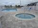 Inviting community pool area featuring a hot tub, swimming pool, and lounge chairs at 665 54Th S St # 133, Gulfport, FL 33707