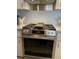 Close-up of the kitchen's stainless steel range/oven with a gas stovetop and sleek vent hood at 665 54Th S St # 133, Gulfport, FL 33707