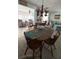 Charming dining area with a wooden table and chairs, a chandelier, and an adjacent living area at 665 54Th S St # 133, Gulfport, FL 33707