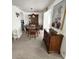 Dining room with a wooden table and chairs, carpet flooring, and a china cabinet at 665 54Th S St # 133, Gulfport, FL 33707