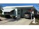 Charming single-story home with a carport, well-kept landscaping, and a car parked on the driveway at 665 54Th S St # 133, Gulfport, FL 33707