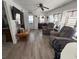 Cozy living room with wood-look flooring, comfortable seating, and plenty of natural light at 665 54Th S St # 133, Gulfport, FL 33707