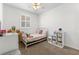 Bright bedroom featuring a bed, desk and closet with large window at 6920 N Hubert Ave, Tampa, FL 33614
