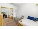 Bedroom featuring a large mirrored closet and a view into another bedroom at 6920 N Hubert Ave, Tampa, FL 33614