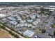 Wide aerial of community showing condominiums, green spaces, parking, and roadways at 6923 Stones Throw N Cir # 4205, St Petersburg, FL 33710