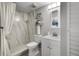 Updated bathroom with shower, marble-look tiles, modern fixtures, floating shelves, and a decorative mirror at 6923 Stones Throw N Cir # 4205, St Petersburg, FL 33710