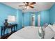 Spacious bedroom features vibrant blue walls, plush bedding, dark furniture, and ample natural light, a cozy retreat at 6923 Stones Throw N Cir # 4205, St Petersburg, FL 33710