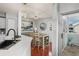 Open dining area with wood floors, modern lighting, and access to an outdoor patio at 6923 Stones Throw N Cir # 4205, St Petersburg, FL 33710