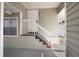 Condo entrance showing stairs to front door with railing and covered entry at 6923 Stones Throw N Cir # 4205, St Petersburg, FL 33710