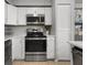 Bright kitchen with stainless steel appliances and white cabinets for a clean and modern look at 6923 Stones Throw N Cir # 4205, St Petersburg, FL 33710