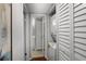 Convenient laundry closet with stackable washer and dryer units, located off the hallway for easy access at 6923 Stones Throw N Cir # 4205, St Petersburg, FL 33710